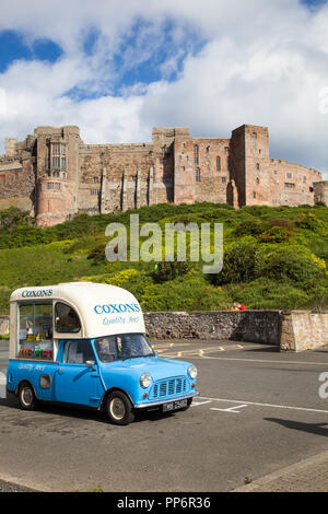 Austin Morris Mini car van converted to an ice cream van parked in front of Bamburgh castle Northumberland England UK Stock Photo