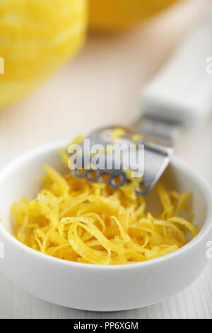 Just scraped lemon zest in the bowl Stock Photo