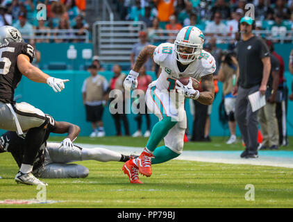 Miami Gardens, Florida, USA. 23rd Sep, 2018. Miami Dolphins wide receiver Kenny Stills (10) runs with the ball past Oakland Raiders cornerback Gareon Conley (21) and defensive back Erik Harris (25) during a NFL football game between the Oakland Raiders and the Miami Dolphins at the Hard Rock Stadium in Miami Gardens, Florida. Credit: Mario Houben/ZUMA Wire/Alamy Live News Stock Photo