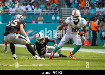 Miami Gardens, Florida, USA. 23rd Sep, 2018. Miami Dolphins wide receiver Kenny Stills (10) runs with the ball past Oakland Raiders cornerback Gareon Conley (21) and defensive back Erik Harris (25) during a NFL football game between the Oakland Raiders and the Miami Dolphins at the Hard Rock Stadium in Miami Gardens, Florida. Credit: Mario Houben/ZUMA Wire/Alamy Live News Stock Photo