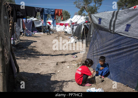 Lesbos, Greece. 24th Sep, 2018. Children play in a temporary camp next to the refugee camp Moria. The camp on the Greek island is overcrowded. Hundreds of people, many of them small children, are waiting under temporary tents, some of which are made of plastic tarpaulins. Wild camps have formed around the establishment of Moria. Credit: Socrates Baltagiannis/dpa/Alamy Live News Stock Photo