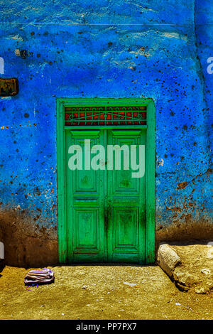 Green doors on a typical colorful house near Medinet Habu in Luxor, Egypt Stock Photo