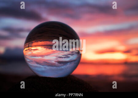 Sunset Seascape Captured in Reflection in Glass Ball Stock Photo