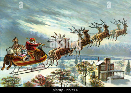 Santa Claus and his reindeer delivering Christmas gifts Stock Photo