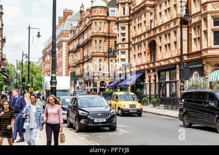 London England,UK,West End City Westminster Mayfair,South Audley Street,historic buildings,shops,pedestrians,woman female women,taxi,UK GB English Eur Stock Photo