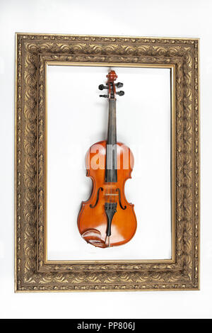 Violin and golden frame on an isolated studio backgound Stock Photo