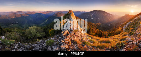 Rocky Panorama of sunset in mountain valley landscape. Stock Photo
