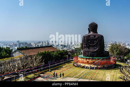 back of Baguashan great Buddha statue from mount Bagua and Changhua cityscape panorama in background in Taiwan Stock Photo