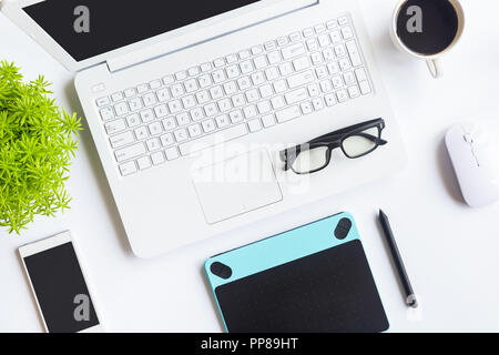 White desk office with laptop, smartphone and other work supplies with cup of coffee. Top view with copy space for input the text. Designer workspace  Stock Photo