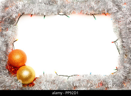 Christmas baubles with lights and silver tinsel frame on white background Stock Photo