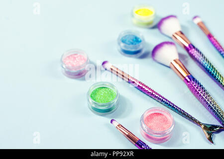 Set of mermaid tail make-up brushes. Make up tools on pastel backg Stock Photo