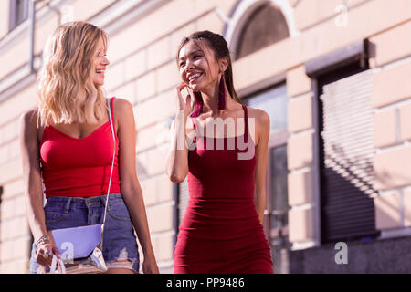 Delighted nice young women having a walk Stock Photo
