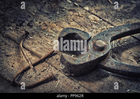 Old rusty tools in the workshop on an old wooden table Stock Photo