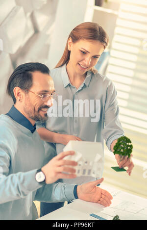 Positive delighted engineers projecting modern housing estate Stock Photo