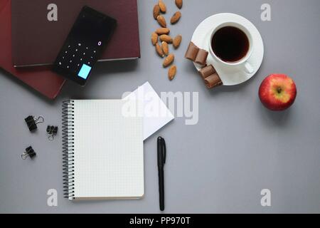 Study stuff. Education background. Stationery. Aspects of education. Food for brain. Marker, notebook, books, an apple, coffee, almonds, chocolate and Stock Photo