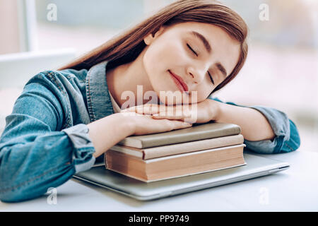 Amazing brunette leaning on pale of her books Stock Photo