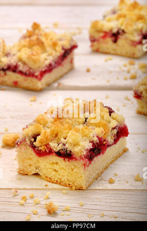 Cake with fruit and crumble on white wooden background Stock Photo