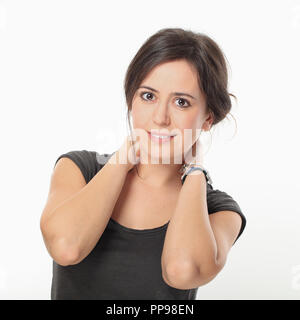 Young nice woman posing with holding hands on her neck Stock Photo