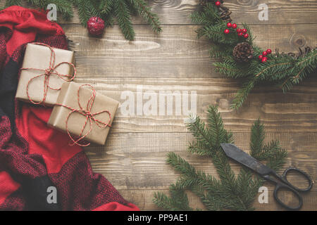 Christmas composition of wreath , checkered pleid on wooden board. Flat lay. Top view. Copy space. Stock Photo