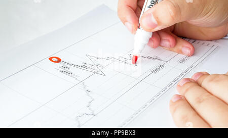 Closeup image of businessman marking point on financial graph Stock Photo