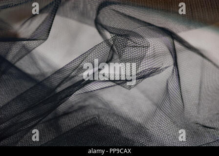 Conceptual Still life close up image of blck fabric netting material  showing holes and texture Stock Photo - Alamy