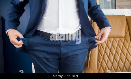 Closeup image of businessman emptying hid pockets at office Stock Photo