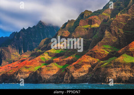 A close up boat view of the famous cliffs of the colorful Nā Pali Coast State Wilderness Park, located on the northwestern side of the island of Kauai Stock Photo