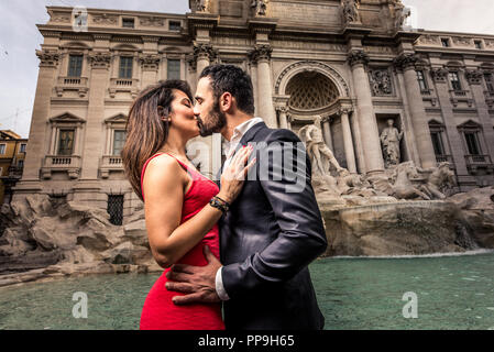 Beautiful couple dating in Rome, Italy -  Boyfriend and girlfriend at Trevi's fountain Stock Photo