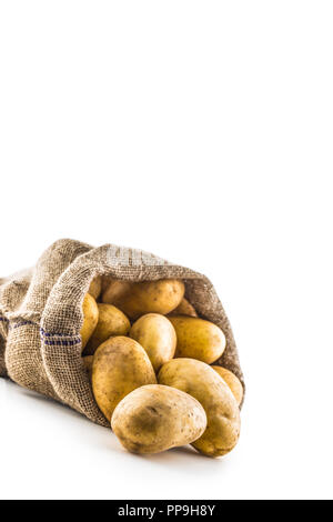 New potatoes in burlap sack isolated on white background. Stock Photo