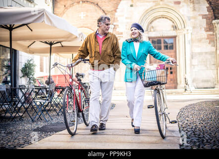 Happy senior couple walking in the city center Stock Photo