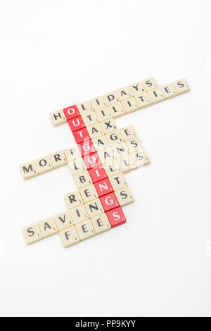 Letter tiles spelling out aspects of personal finances / financial management, and running up bills, debts, personal loans etc. Stock Photo
