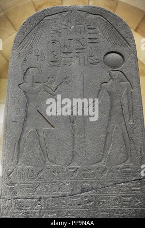 Egypt. Stele of Seti I. Beth-Shean. 1289-1278 B.C. Basalt. Commemorates the king's victory in the Military expedition into Canaan. The pharaoh (left), crowned with an Uraeus, presents the libation and incense to the sun god Re-Harakhty. Relief. 19th Dynasty. New Kingdom. Rockefeller Archaeological Museum. Jerusalem. Israel. Stock Photo