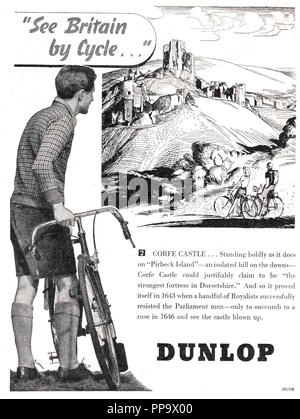 Vintage Dunlop magazine advertisement 'See Britain by cycle' dated to October 1946. It shows an illustration of Corfe castle in Dorset with a brief history of the castle Stock Photo