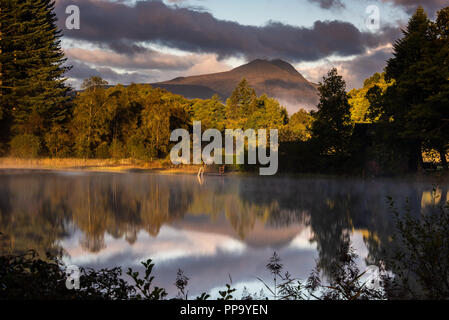 Looking across to Ben Lomond from Loch Ard in the Trossachs National Park at sunrise Stock Photo