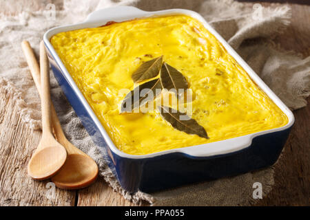 Bobotie (South African curried mince pie)  close-up in a baking dish on the table. Horizontal Stock Photo