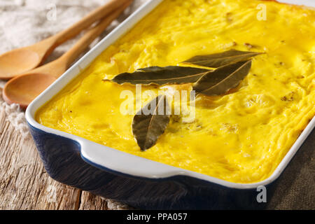 Bobotie (ba-boor-tea) is the national dish of South Africa. It's a type of meat pie that incorporates curried meat, fruit, and a delicious egg-based t Stock Photo