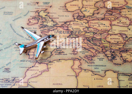 Airplane over the map of Europe. Toy airplane on the map background. Stock Photo