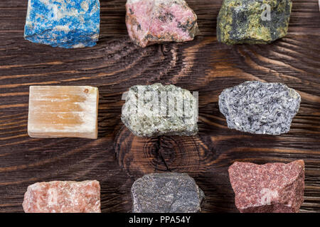 Collection set of minerals and stones on the old wooden table. Stock Photo