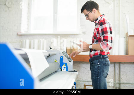 Man working in printing office Stock Photo