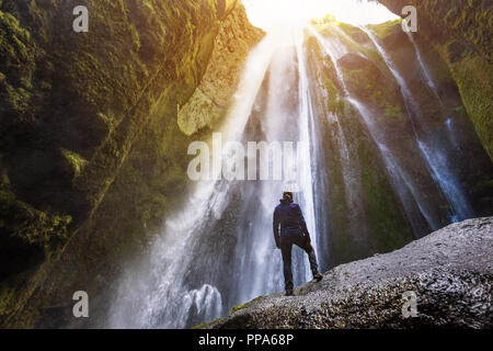 Gljufrabui waterfall in South Iceland,  adventurous traveller standing in front of the stream cascading into the gorge or canyon, hidden Icelandic lan Stock Photo
