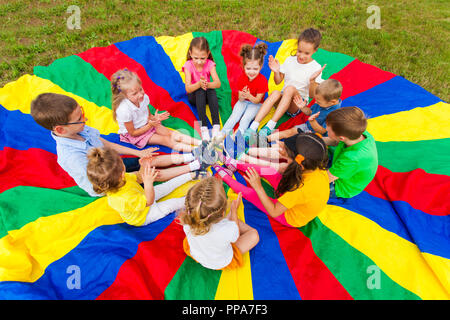 Kids clap the hands in the summer outdoors Stock Photo