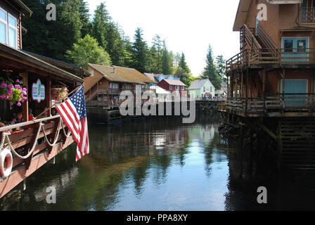 Shops and restaurants in wooden buildings built over water in Ketchikan, Alaska. Stock Photo