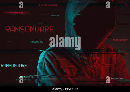 Ransomware concept with faceless hooded male person, low key red and blue lit image and digital glitch effect Stock Photo