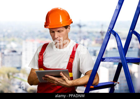 Confident foreman working on digital tablet. Stock Photo