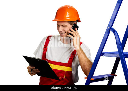 Smiling foreman talking on cell phone. Stock Photo
