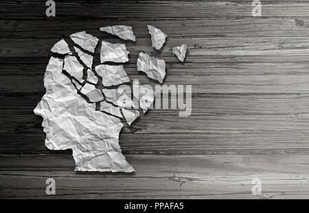 Parkinsonâ€™s patient disease and parkinson disorder symptoms as a human head made of crumpled paper with broken pieces representing health loss. Stock Photo