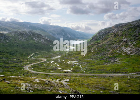 Road leading towards distance in a valley between mountains Stock Photo