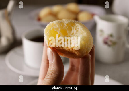 https://l450v.alamy.com/450v/ppagaj/close-up-of-a-bitten-homemade-brazilian-cheese-bread-also-known-as-po-de-queijo-breakfast-table-setting-in-the-background-selective-focus-ppagaj.jpg