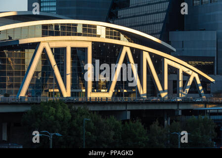 Iconic typographic architecture of the State Farm Arena appears spotlit by the rising sun at sunrise in downtown Atlanta, Georgia. (USA) Stock Photo