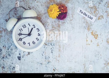 To Do List Fall Time concept with fall decor and white alarm clock, flat lay Stock Photo